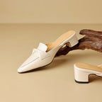 Marloe Spitz zulaufende Leder-Mules" could be rewritten as "Marloe Leder-Mules mit spitz zulaufendem Design.